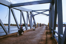 motorcycles crossing a bridge in Cambodia 