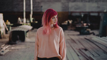 a young woman with pink hair 