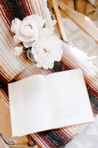 peonies and book in a chair 