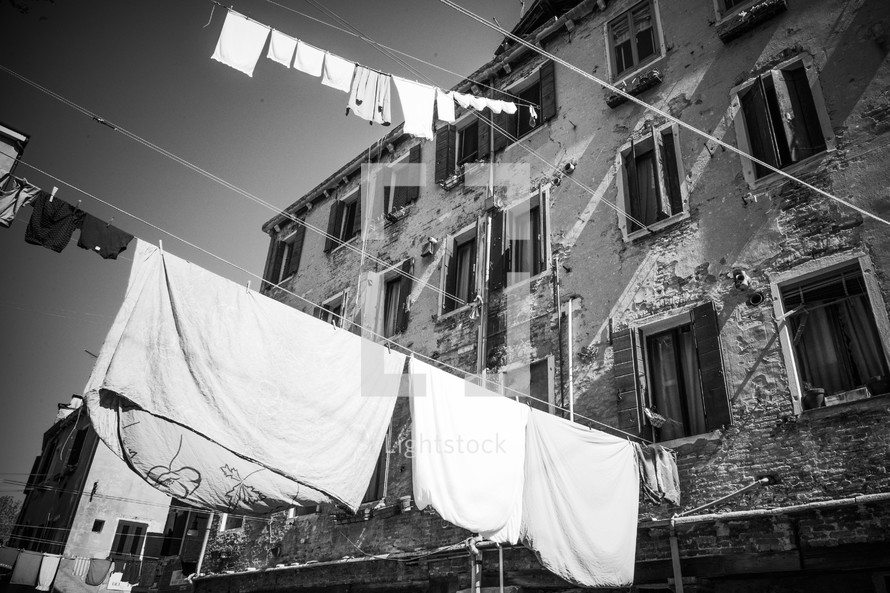 Run down, shabby apartment building with clotheslines extending from the windows.
