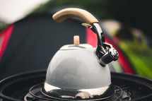 tea pot on a propane burner 