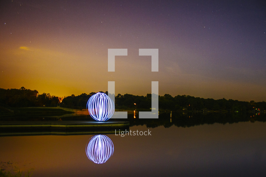 glowing ball of light and a lake 