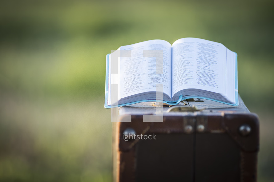 open Bible on a suitcase 