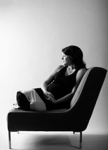 pregnant woman sitting on a chair 