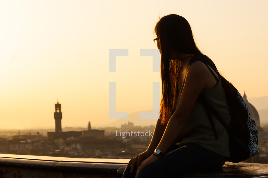 Young teen at sunset watching the view of Florence