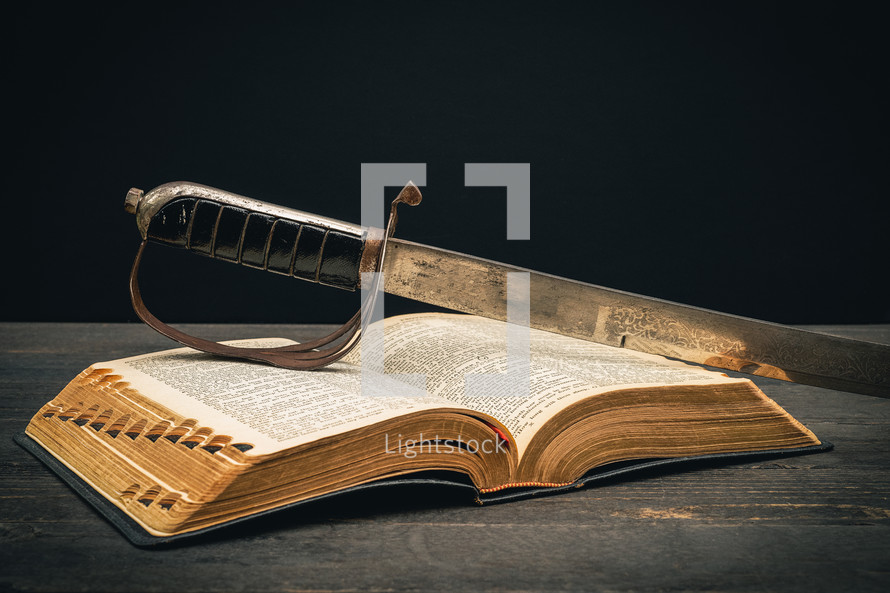 a sword on the pages of a Bible 