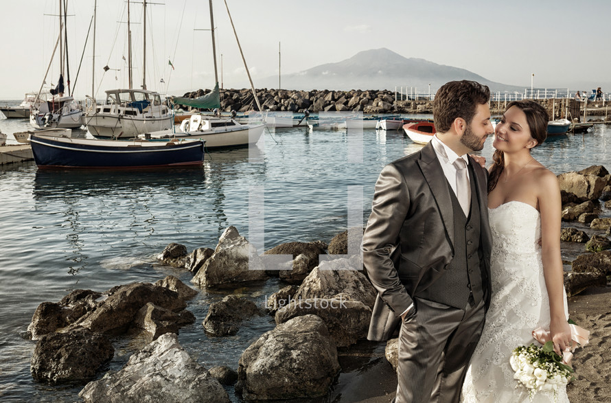 bride and groom at a harbor 