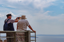 elderly couple taking pictures of the ocean from Trigoniou Tower, Thessaloniki, Greece