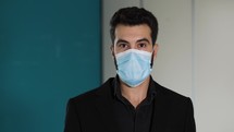 a businessman in a face mask 