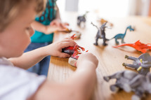 kids playing with toy dinosaurs 