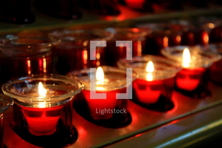 Beautiful red glowing candles at a Christmas Eve service at a local house of worship church service. 
