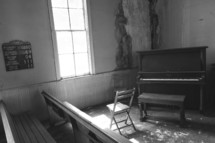 piano in a corner of an old church 