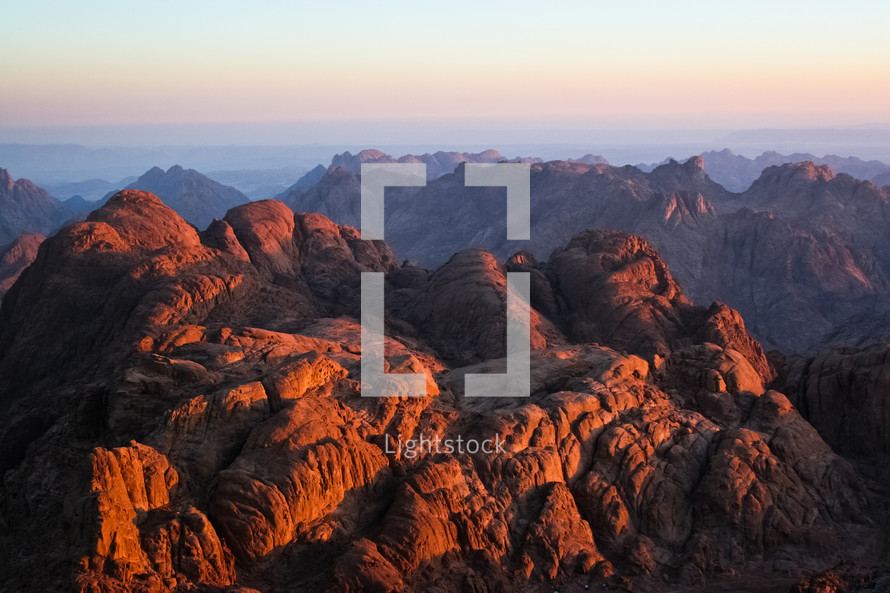 A sunrise shines on the mountains around Mount Sinai, Egypt.