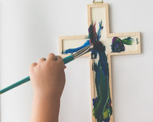 a child painting a cross 