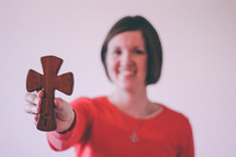Wood cross being held in the hand of a woman