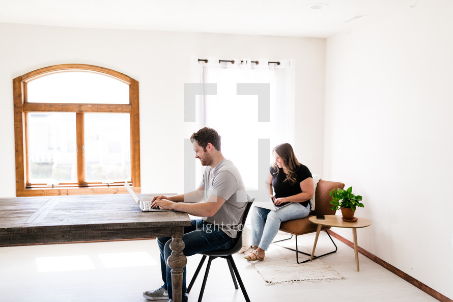 a husband and wife working from home 
