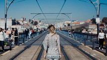 woman walking on electric rail tracks 