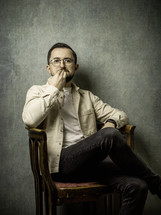 Portrait of a man thinking in a chair