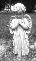 This little guardian angel stands over a tomb praying in this black and white photo that I captured in a local cemetery. 