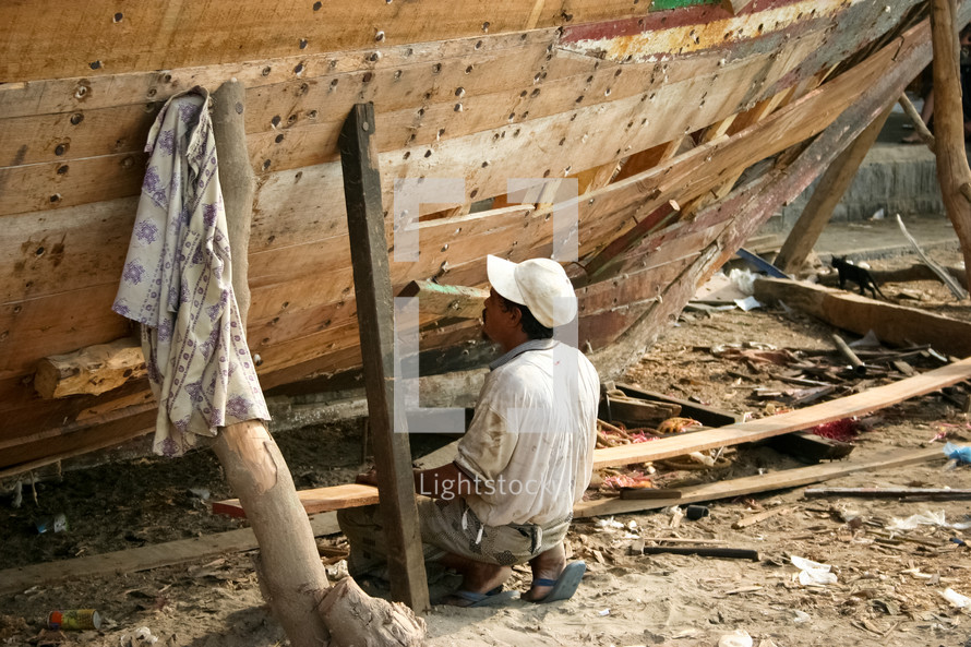 a man building a boat in Yemen 
