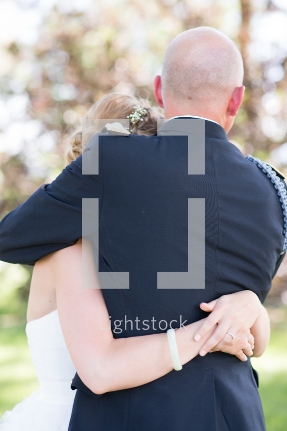 Embrace between a father and daughter on her wedding day.