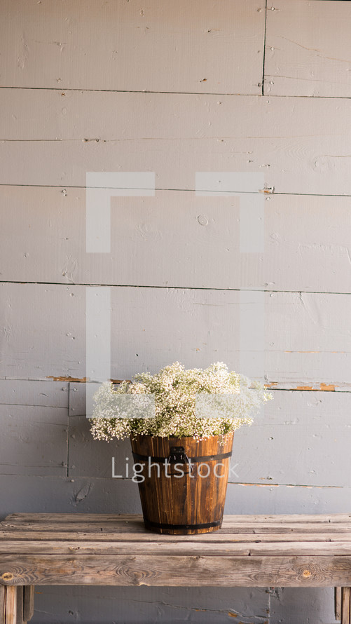 Bouquet of flowers on a wooden table outside.