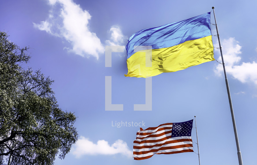 Ukranian and American flags on flagpoles 