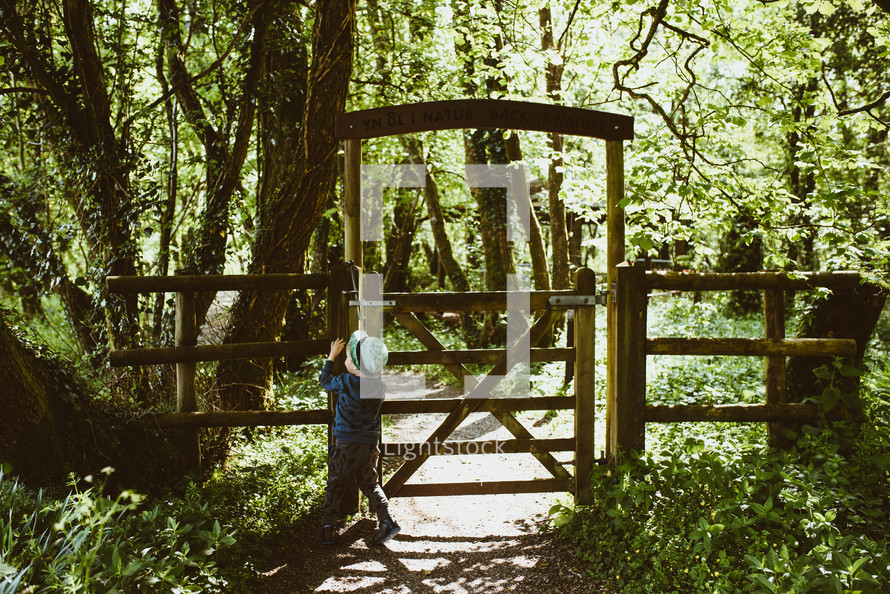 a child standing by a gate