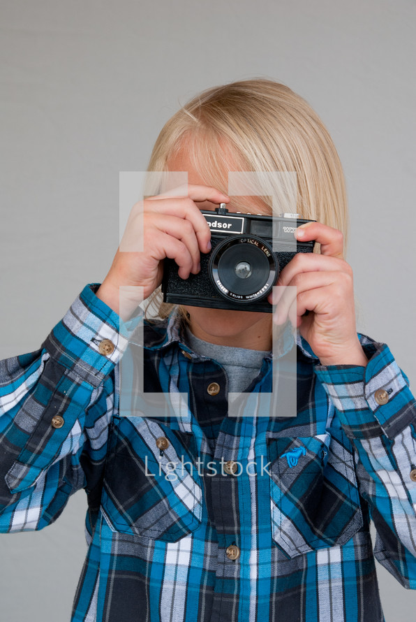 boy child holding a camera 