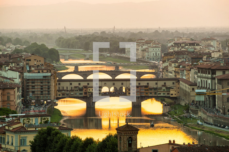 Arno river and famous Ponte Vecchio enlighten by the warm sunlight. Florence, Italy