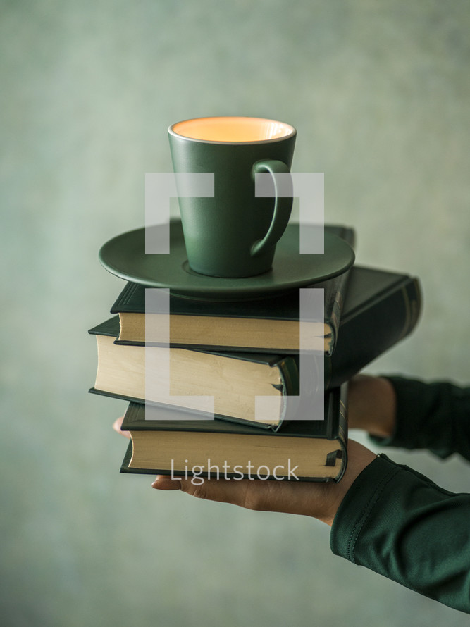 coffee cup on a stack of books 
