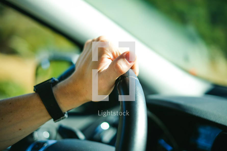 hand on a steering wheel 