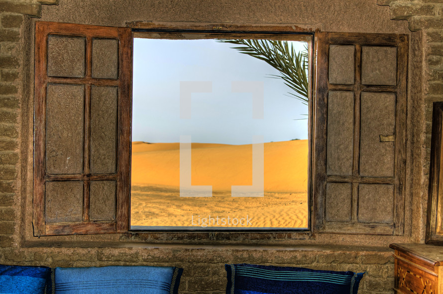 view of the desert through an open window 