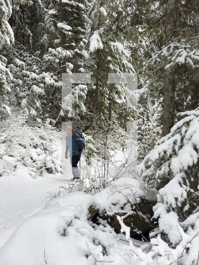Hiker in a snowy mountain wilderness. 
