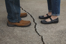 man and woman separated by a crack 