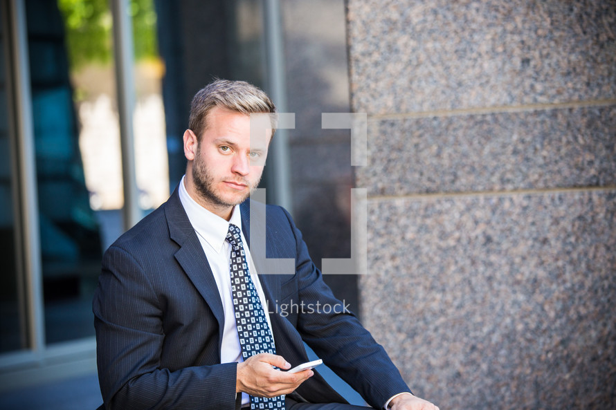 portrait of a businessman holding a cellphone 