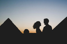 silhouette of a couple and the pyramids in Egypt 