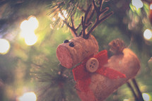 reindeer ornament made out of corks hanging on a Christmas tree 