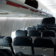 rows of empty seats on an airplane 