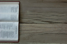 Hebrew Bible open to the book of Habakkuk on a wooden floor.