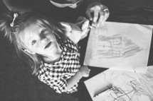 toddler girl coloring with crayons 
