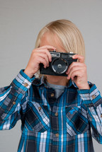 boy child holding a camera 