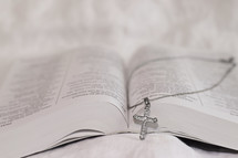 cross necklace on a Bible 