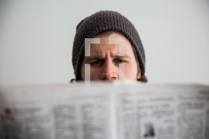 man reading a newspaper.