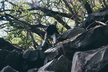 a man climbing down a rocky terrain 