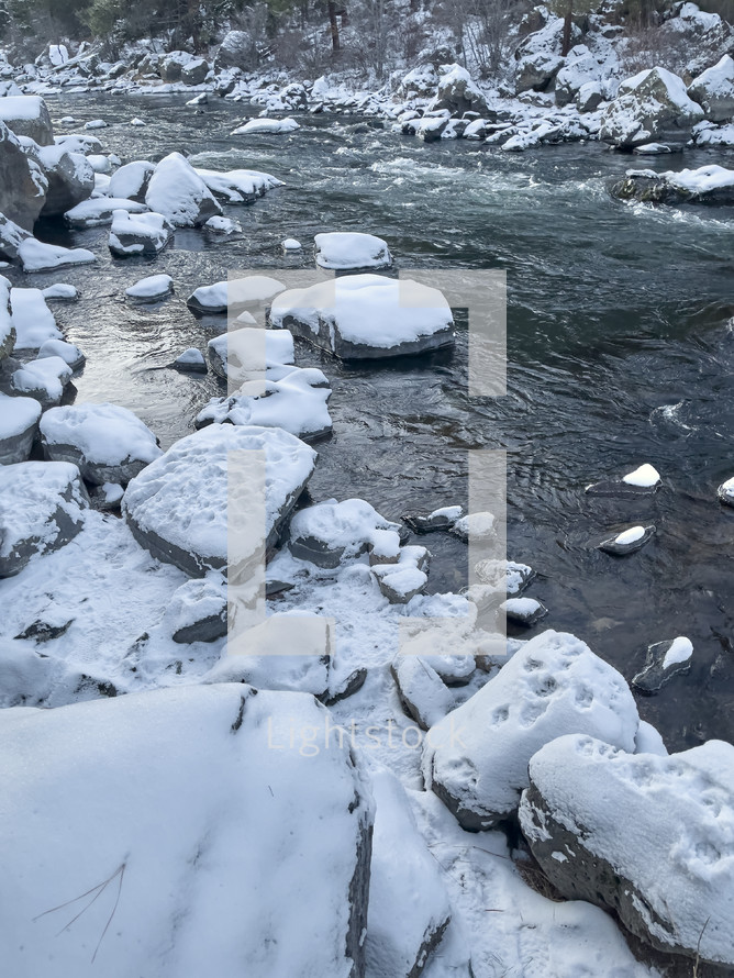 Snow covered rocks in a stream