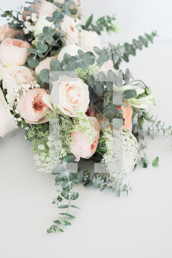 a bouquet of roses with eucalyptus 