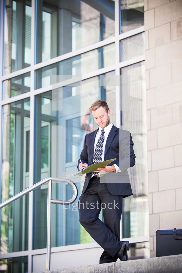 businessman writing in a notebook 