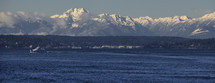 The snow covered Olympic mountains on a spring day.
