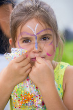 a girl child with face paint 